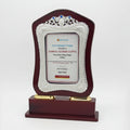 Decorative trophy with a certificate on a wooden base, featuring pricing information.
