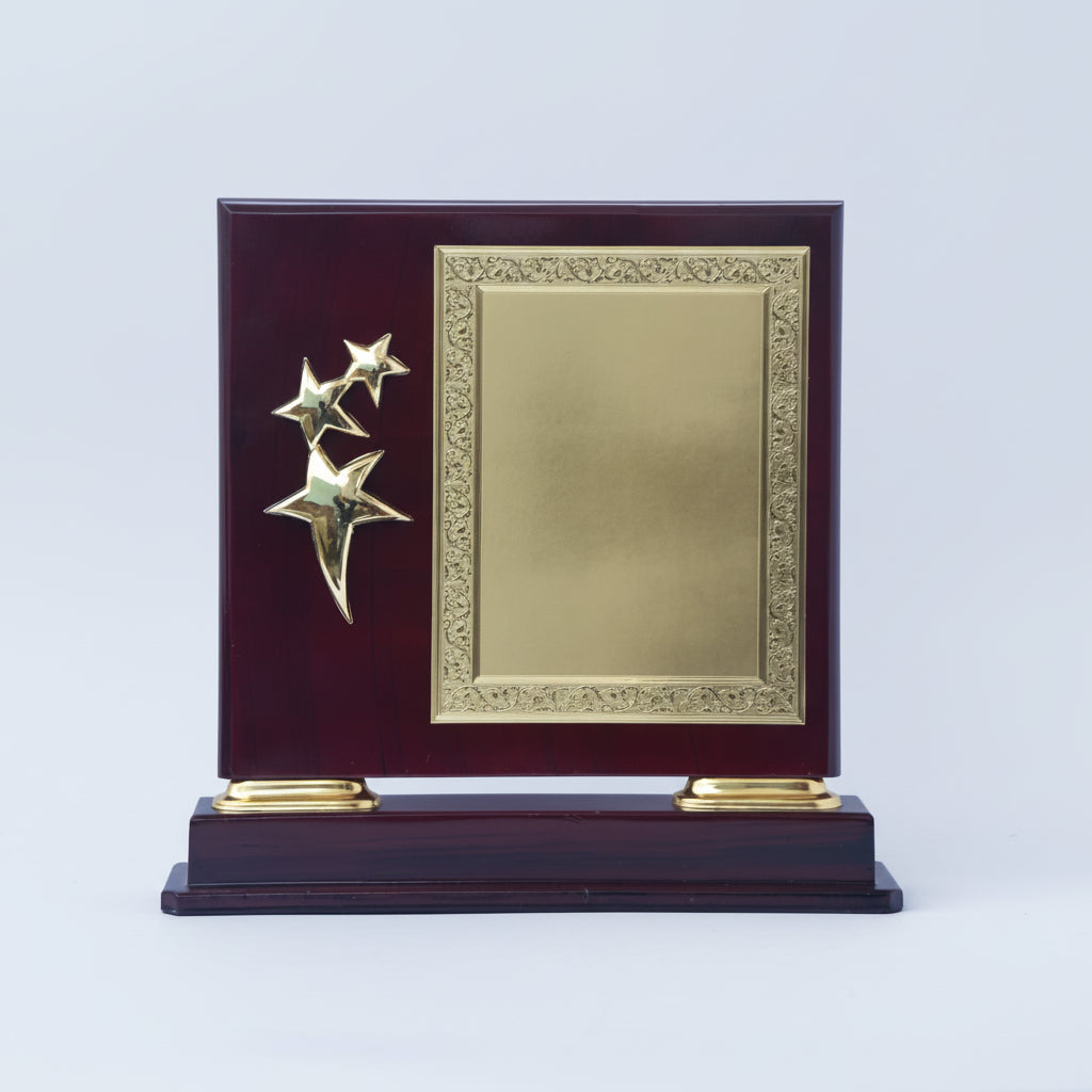 Decorative plaque with gold stars on a dark wood base