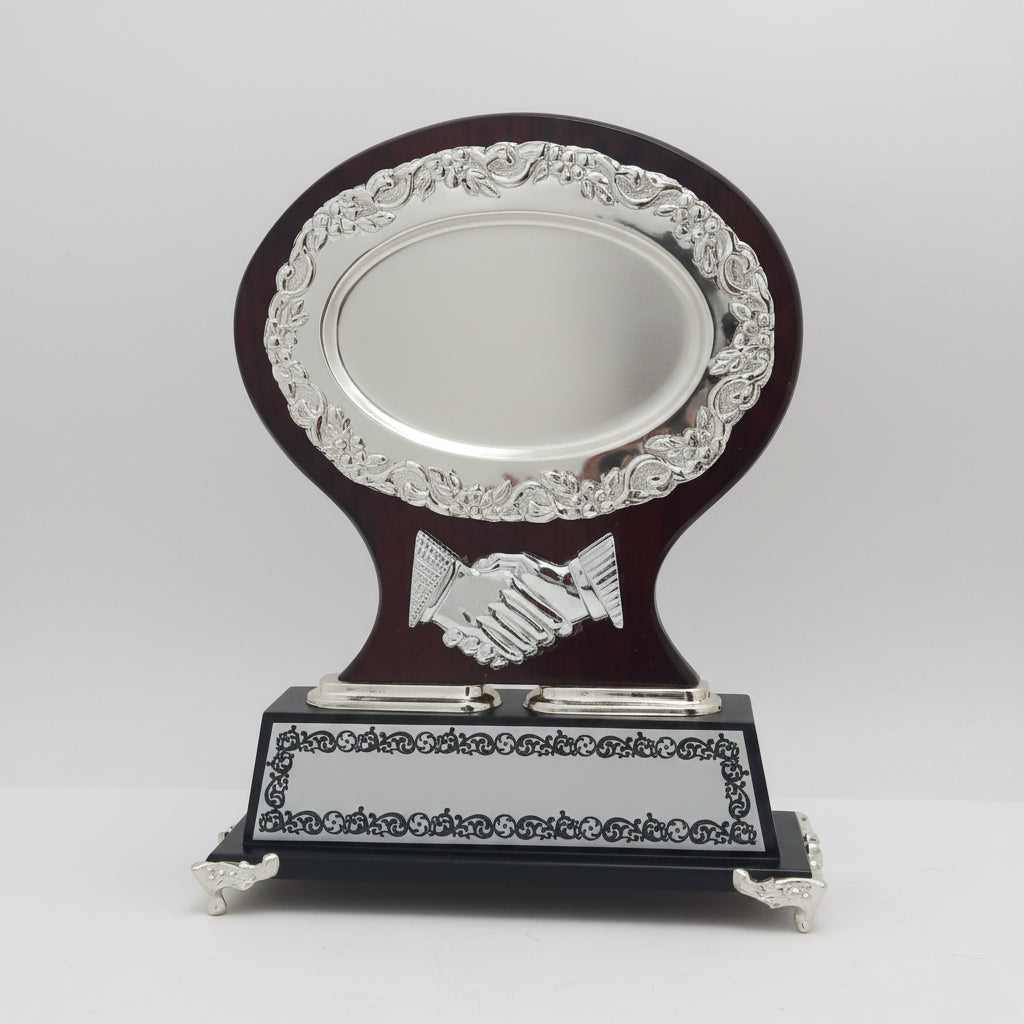Decorative trophy with a handshake emblem on a wooden base