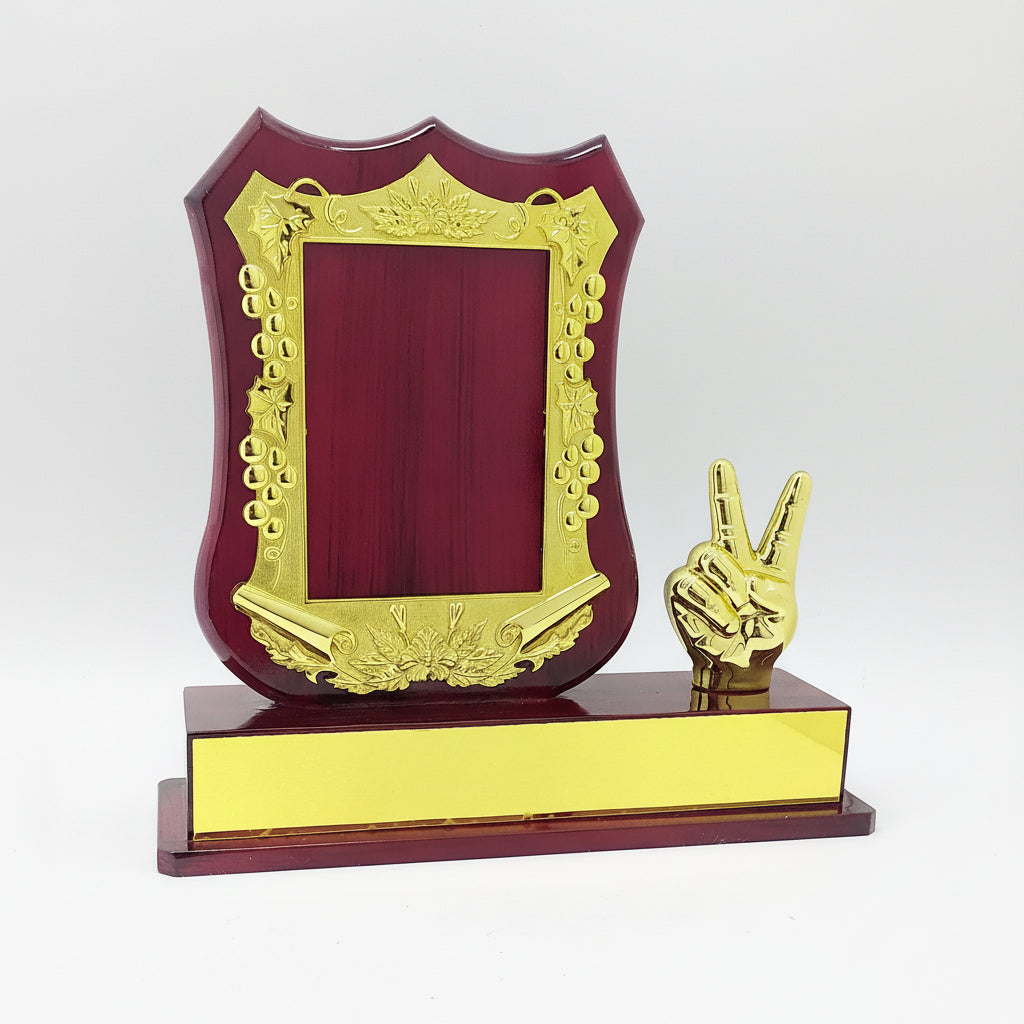 Decorative award with gold frame and peace sign on a red base, featuring product code and price.
